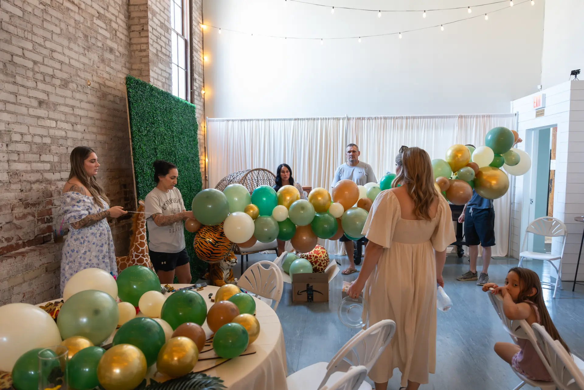 Jungle-themed baby shower setup with greenery and balloons at Host Wenatchee