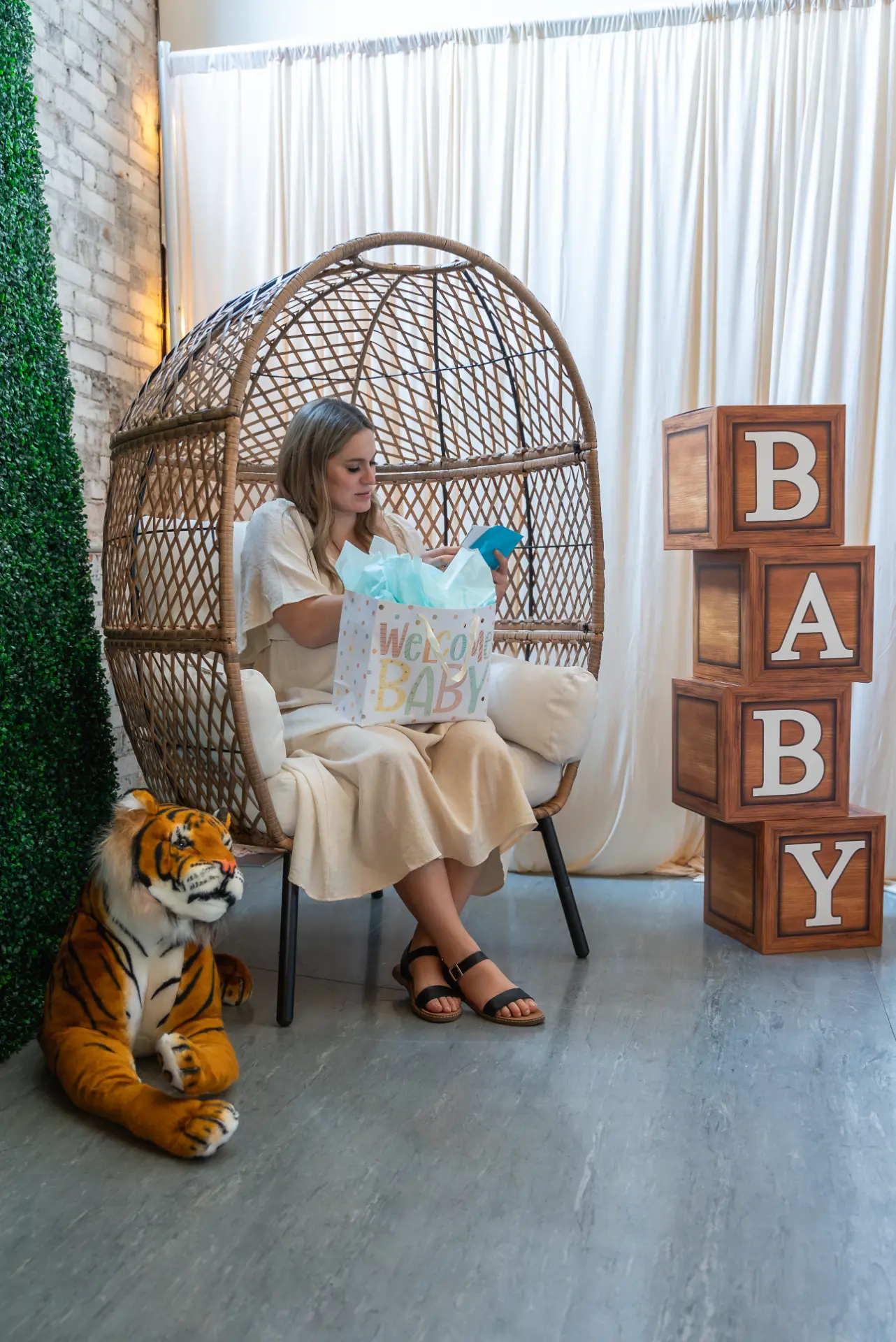 Hanging egg chair photo spot decorated for a baby shower at Host Wenatchee