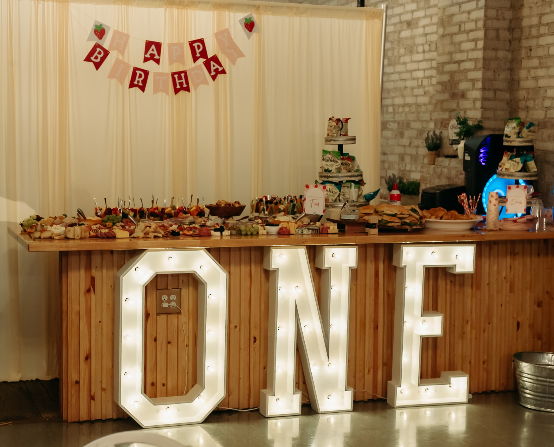 Balloon backdrop and cake table set up for a celebration at Host Wenatchee
