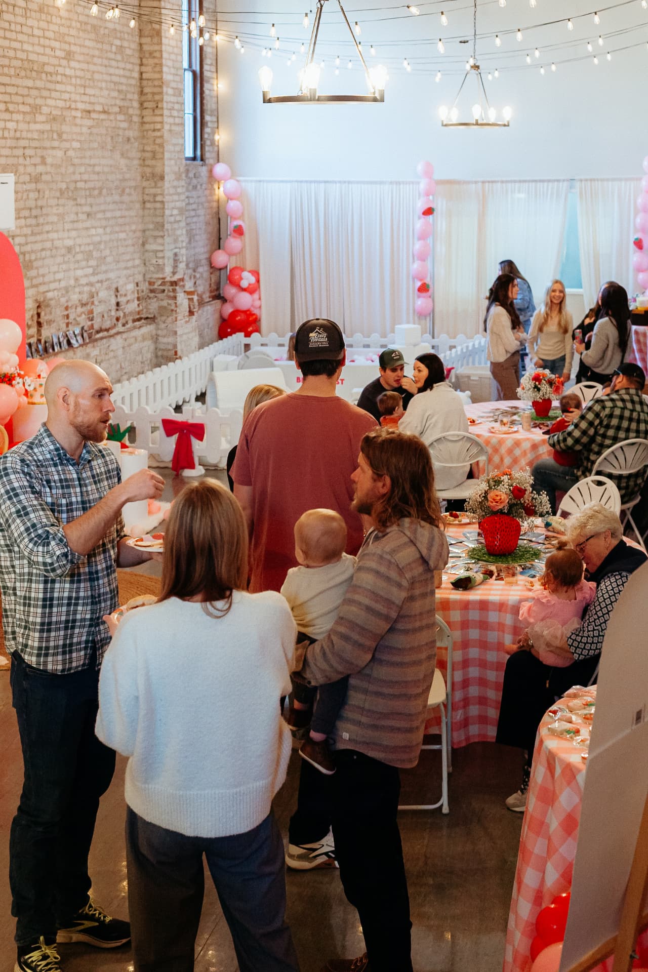 Guests gathered around the dessert table at a birthday party at Host Wenatchee