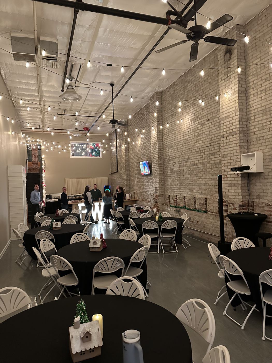 Round banquet tables with white linens and centerpieces set for a reception at Host Wenatchee